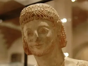 Rampin Rider sculpture showing the head and upper torso of a weathered ancient male figure with curly hair and a short beard.