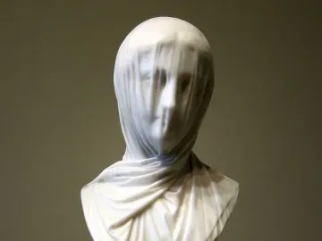 The Veiled Nun marble bust with a translucent veil draped over the woman’s face and shoulders.