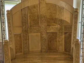 Throne of Maximian, an ornate ivory throne with carved panels of robed figures and decorative animal motifs.