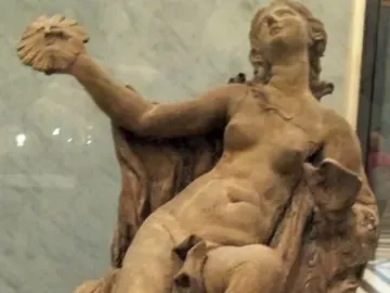Truth Unveiled by Time sculpture showing a reclining nude female figure holding a disc aloft, with a rough unfinished figure behind her.