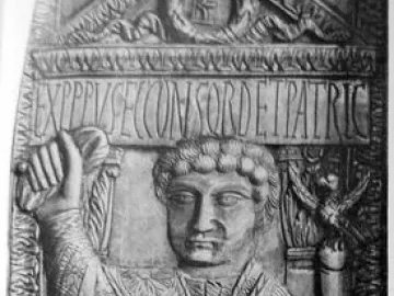 Carved consular diptych of Boethius showing a seated man in a patterned robe holding a staff, with a Latin inscription above and objects at his feet.