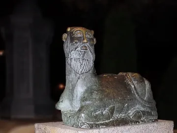 Bicha of Balazote sculpture with a bearded human head and reclining animal body on a stone base.