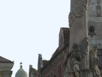 Lower and middle sections of the Holy Trinity Monument with sculpted figures and ornate Baroque decoration.