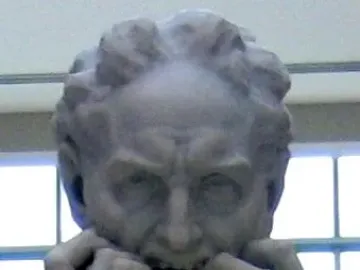 Close-up of Ugolino and His Sons showing a white marble figure with a deeply distressed expression and clenched hands at his face.