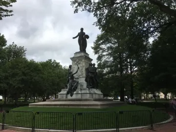 The Marquis de Lafayette statue, a large bronze monument with figures on a stone pedestal in a fenced park.