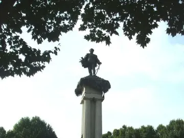 Monument to Vittorio Emanuele II with a bronze statue on a columned pedestal and sculptural figures at the base.