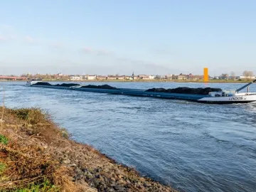 The Rhine Orange stands on the distant riverbank beside the Rhine in Duisburg.