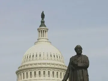 James A. Garfield Monument with a bronze statue of James A. Garfield in front of the U.S. Capitol dome and columns