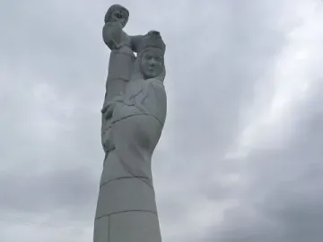 Our Lady of the Isles statue with a crowned woman holding a child on a stone base