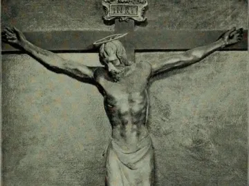 Santa Croce Crucifix showing a wooden Christ figure on the cross with bowed head, halo, loincloth, and INRI plaque above.