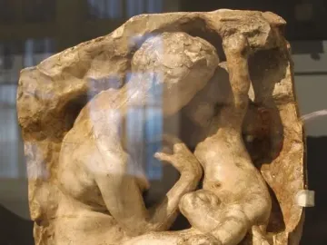 Young Mother in the Grotto relief showing a crouching adult embracing a child.