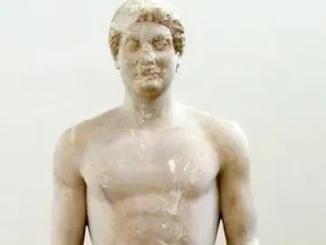 Aristodikos Kouros, a nude marble male statue with missing forearms, standing on a base.