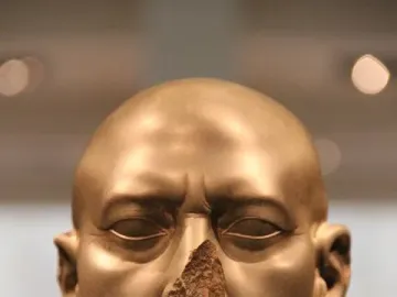 Berlin Green Head, a damaged greenish-brown stone bust with a missing nose and stern expression.