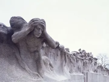 The Fountain of Time sculpture with many stone figures in a solemn procession.