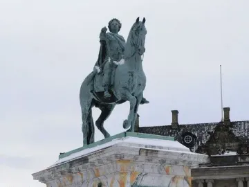 Frederick V equestrian statue on a marble pedestal with chain fencing in a snowy square