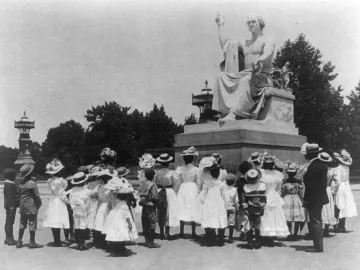 Horatio Greenough’s marble statue of George Washington with a group of children and women gathered in front of it.