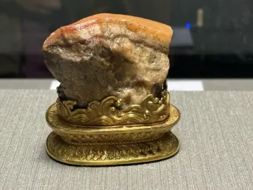 Meat-Shaped Stone carved like a piece of pork belly on an ornate gold stand.