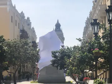 Francisco Pizarro Equestrian Statue covered with a white sheet on a stone base in a public plaza.