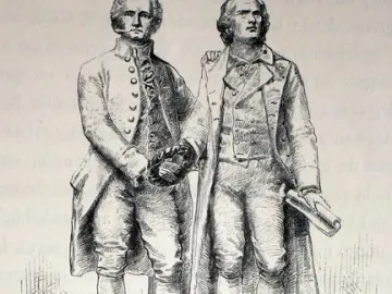 Goethe and Schiller Monument showing two standing male figures on a tiered stone pedestal, one holding a wreath and the other a rolled document.