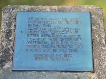 Verdigris plaque on the UFO Memorial with engraved Swedish text and dates.
