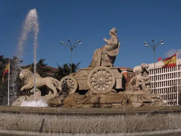 Cibeles Fountain with the goddess seated in a chariot drawn by lions, with water spraying around the base.