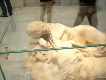 Sleeping Maenad reclining marble statue of a nude woman resting her head on her arm, with visible repair patches.