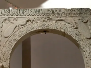 Archway from the Baptistry of Callistus with peacocks, a Latin inscription, and carved floral and geometric decoration.