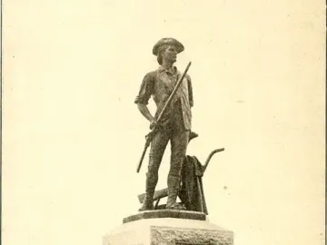 The Minute Man statue stands on a stone pedestal in a grassy area, holding a long gun with carved reliefs and inscriptions on the base.
