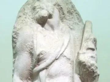 Saint Matthew, an unfinished marble sculpture of a bearded male figure emerging from rough stone.
