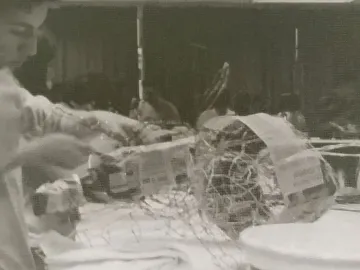 Wire mesh Alebrije structure being covered with newspaper and paper.