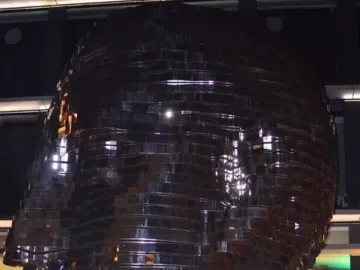 The Head of Franz Kafka sculpture in Prague, a towering reflective metal head made of layered panels.