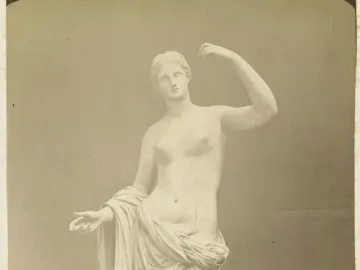 Townley Venus, a classical female statue standing on a pedestal with one arm raised and the other extended forward.