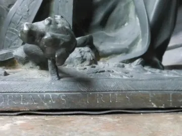 Close-up of a weathered sculpture base in the Mausoleum of Prince Ernst, showing the inscription \