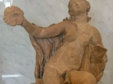 Truth Unveiled by Time, a reddish-brown marble statue of a nude woman with her head tilted back and her left hand raised holding a shell-like object.