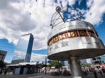 The World Clock in Alexanderplatz, a cylindrical public clock with city names and times beneath a globe structure.
