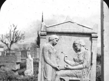 Grave Stele of Hegeso showing two women in classical drapery, one seated and holding a small object while the other stands beside her.