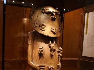 Carved wooden figure of A\'a covered with small raised figures