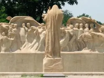 Lorado Taft\'s Fountain of Time sculpture with a central robed figure overseeing a long procession of human figures.