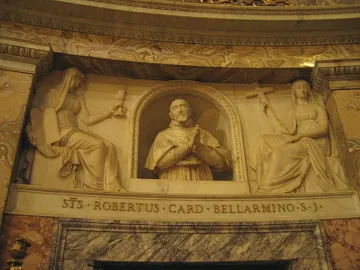 Marble relief of Cardinal Roberto Bellarmine in a niche, flanked by seated female figures holding a chalice and a cross.