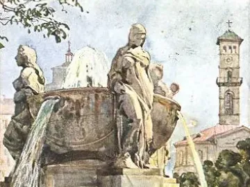 Nornenbrunnen fountain with draped female statues and a church tower in the background.