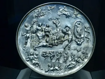 Parabiago Plate with a circular relief of mythological figures, including a central chariot drawn by lions.