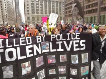 The Picasso sculpture rises above a crowd of protesters in downtown Chicago.