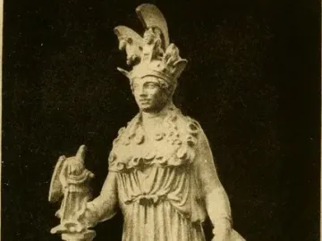 Varvakeion Athena statuette showing a standing armored figure with helmet, shield, and a small figure atop a tall support.