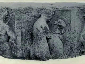 Worn relief sculpture from the Pilier d\'Yzeures-sur-Creuse showing several carved human figures in horizontal arrangement.