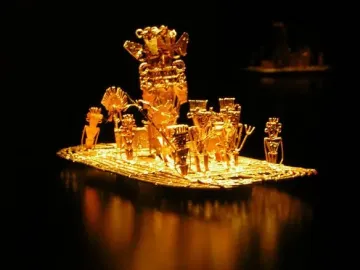 Muisca Raft with a central figure and surrounding oarsmen in a gold-colored sculptural model