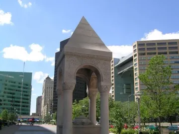 Bagley Memorial Fountain with a pyramidal roof, carved arches, and a lion-head relief in Detroit\'s Cadillac Square.