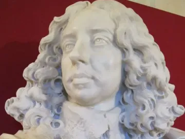 Bust of Francesco I d\'Este in white marble, with curly hair, a mustache, and a lace collar.
