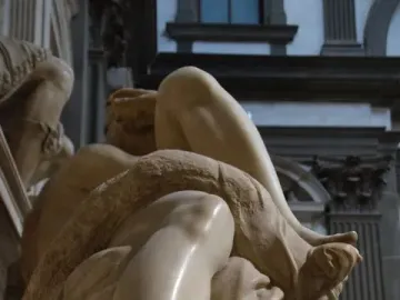 Close-up of Michelangelo’s Evening showing the reclining marble figure’s bare legs and foot.