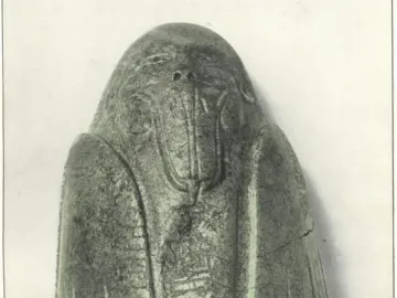 Tuxtla Statuette with an elongated carved head, protruding mouth, and incised decorative patterns