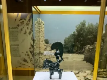 Warrior of Moixent figurine of a horseman with a crested helmet and round shield in a display case.
